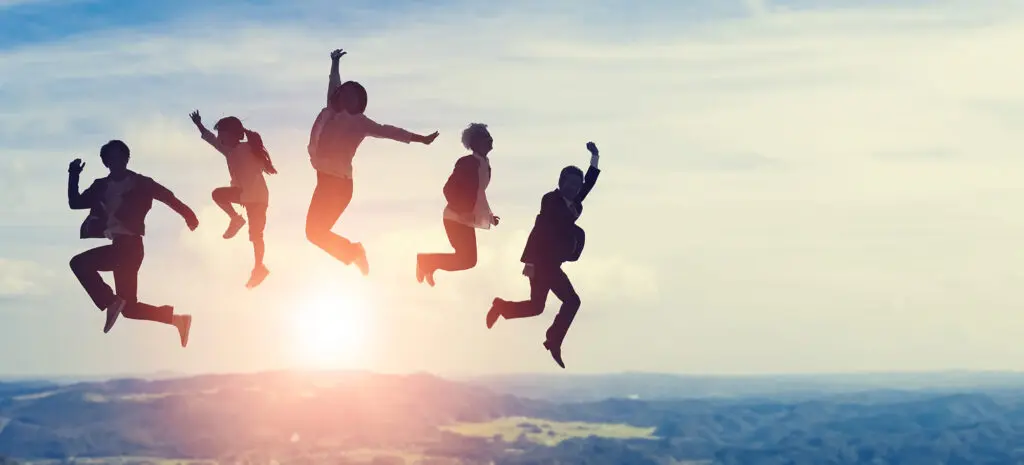 Silhouette of group of people jumping in front of nature. Happy family.